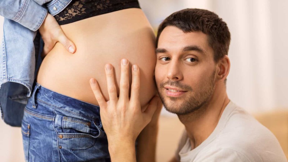 Husband touching pregnant wife's belly