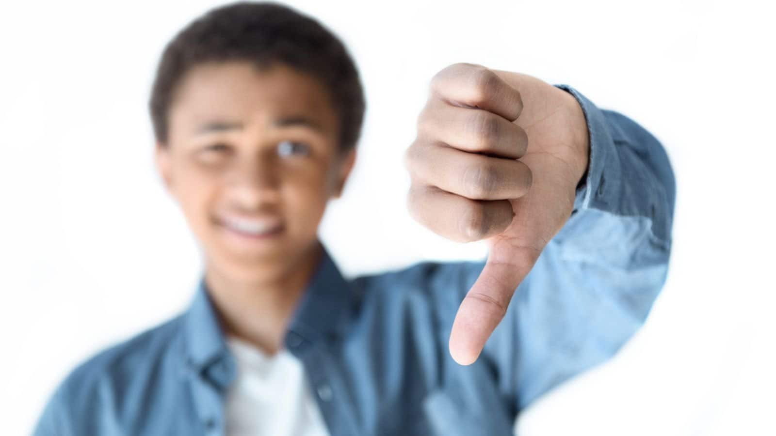 African american teenager showing thumb down