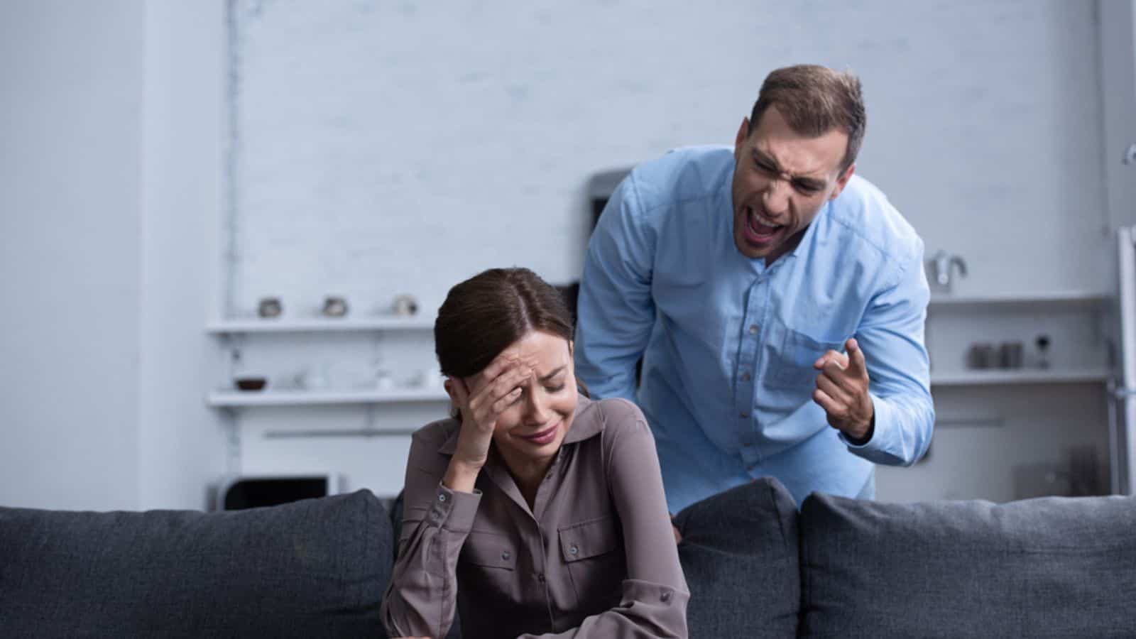 Aggressive man in shirt screaming at wife during quarrel