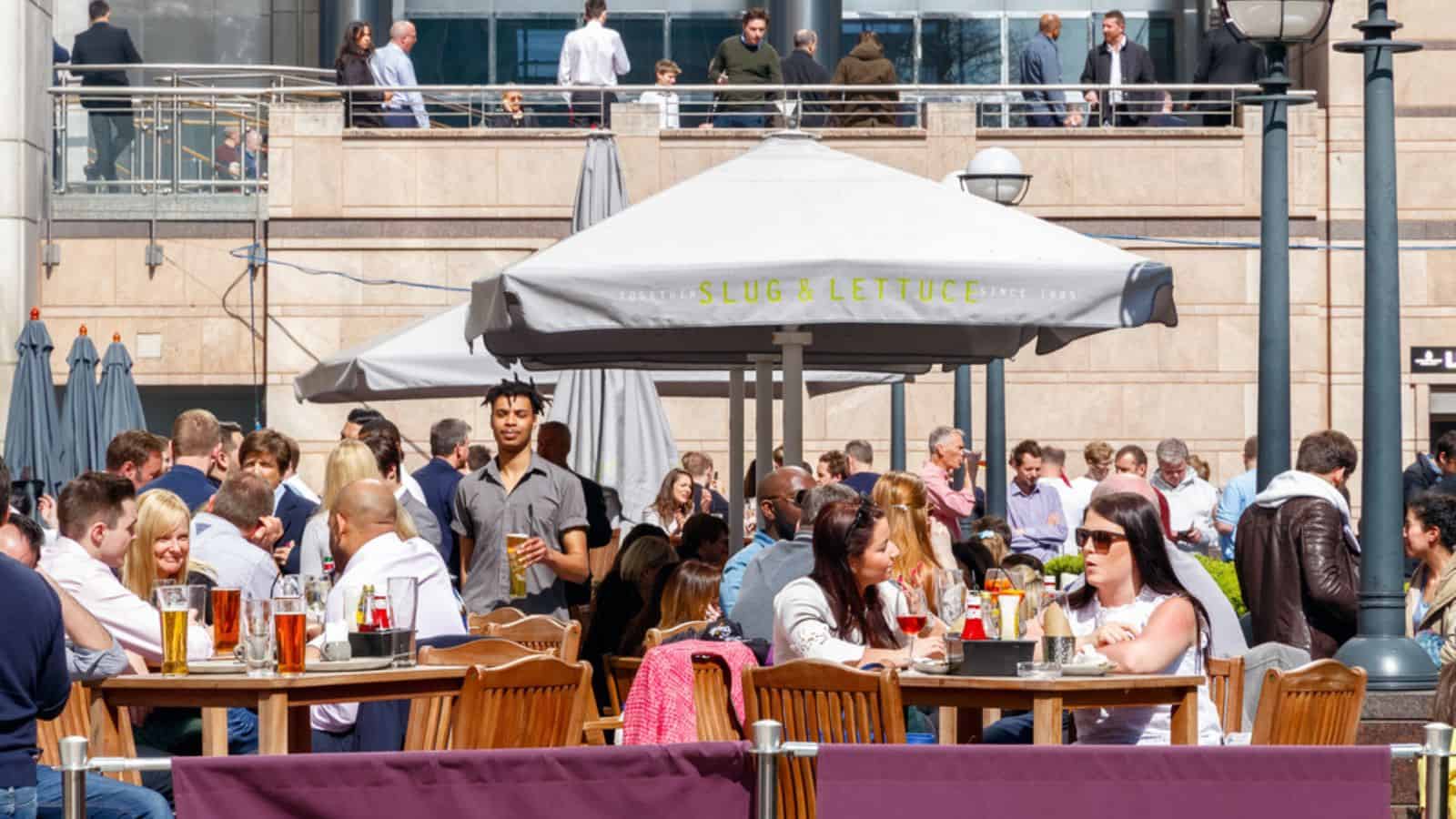 An outdoor bar in Canary Wharf packed with people