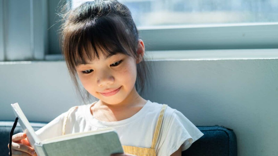 Asian Child Reading Book