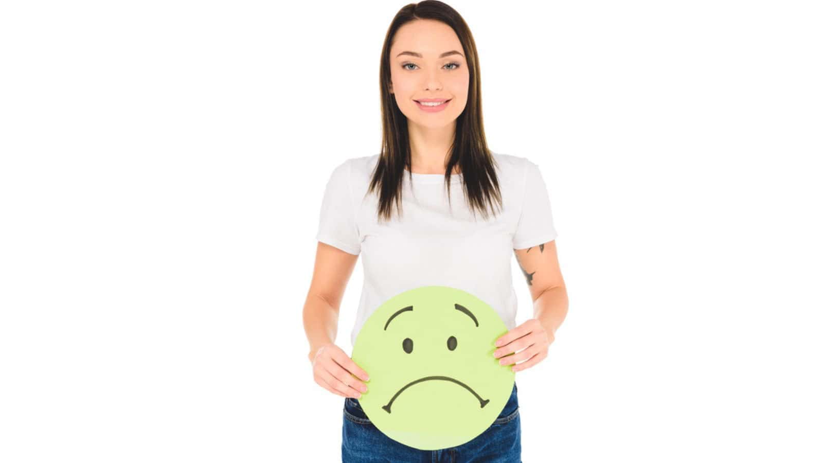 Attractive girl holding green sign with sad face expression