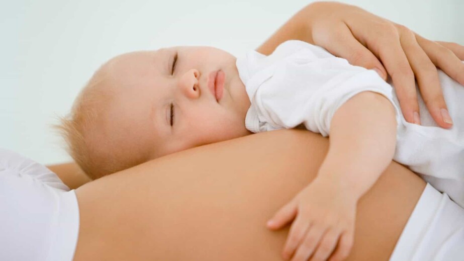 Baby sleeping on pregnant's woman stomach