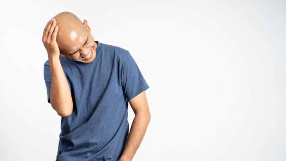 Bald Man Laughing Holding His Bald Head