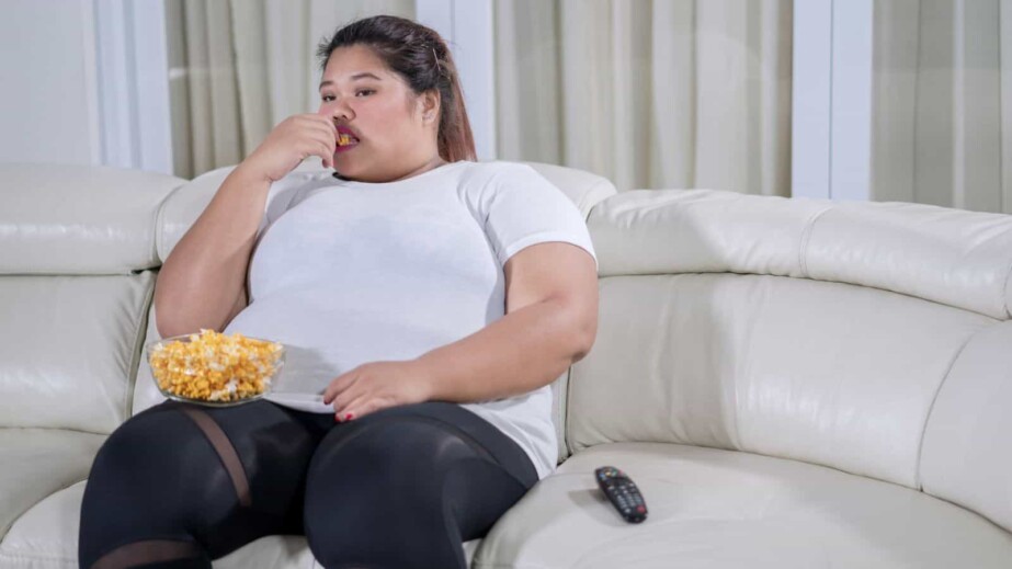 Bored Fat Woman Watching Television at Home