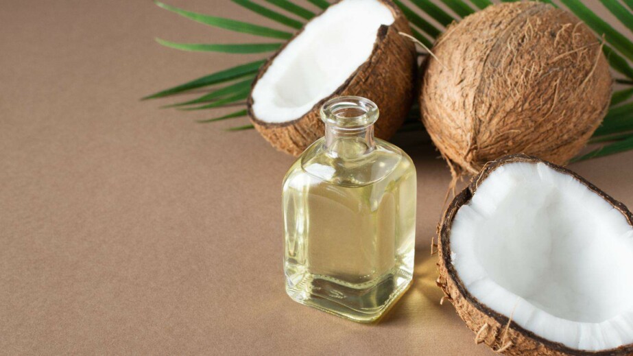 Bottle of Coconut Oil and Fresh Coconuts