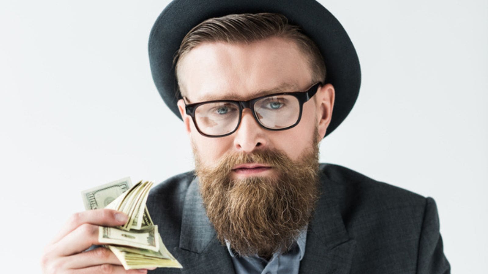 Businessman with vintage mustache and beard holding dollars