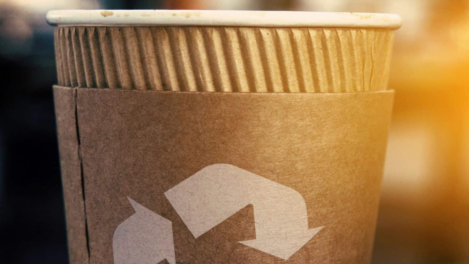 Coffee cup with recycling sign