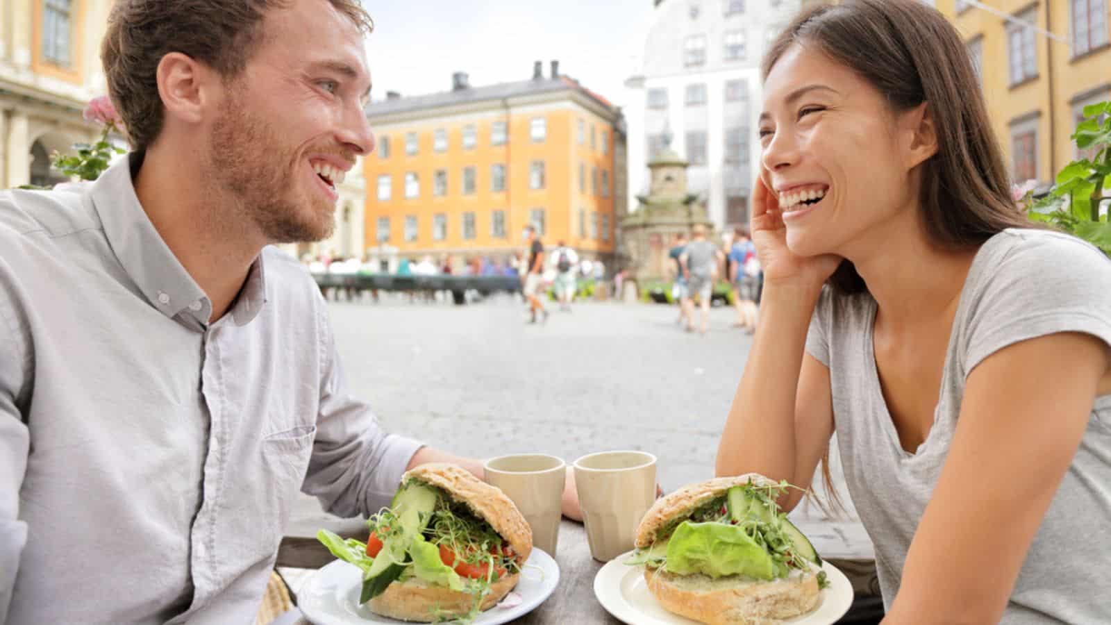Couple eating food sandwiches in Stockholm