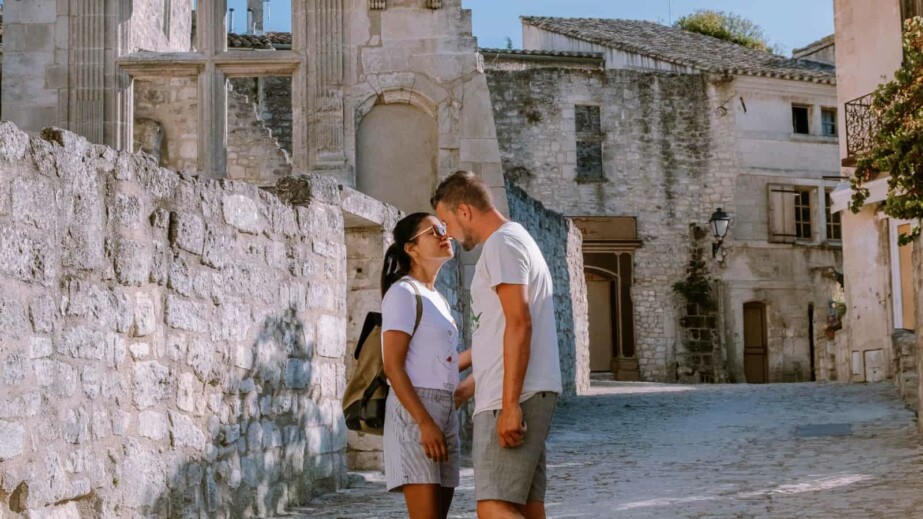 Couple kissing beside ancient ruins