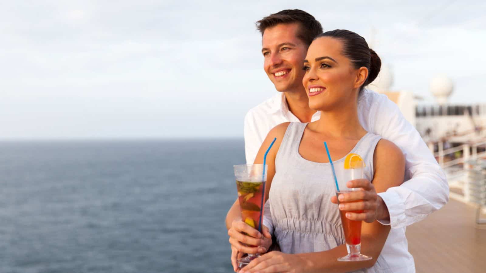 Couple on cruise holding cocktails