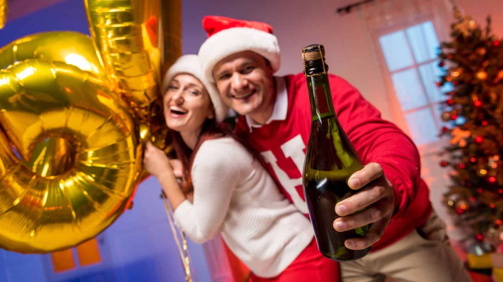 Couple with balloons and champagne bottle