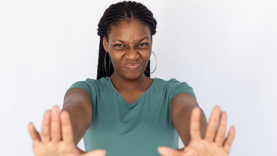 Disgusted woman making stop gesture