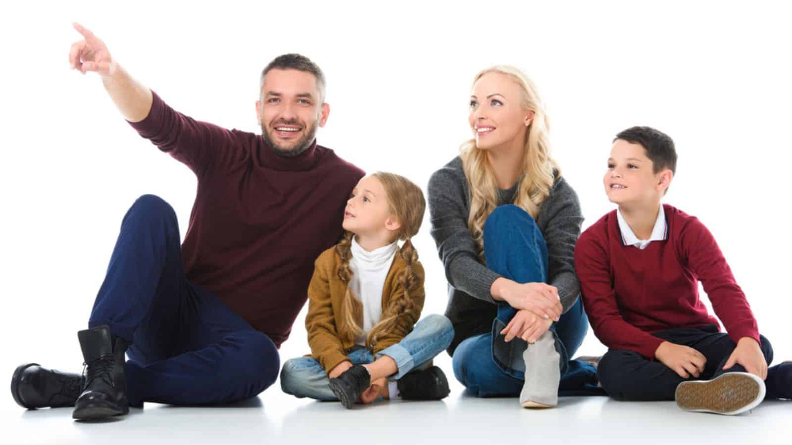 Family with adorable children sitting on floor