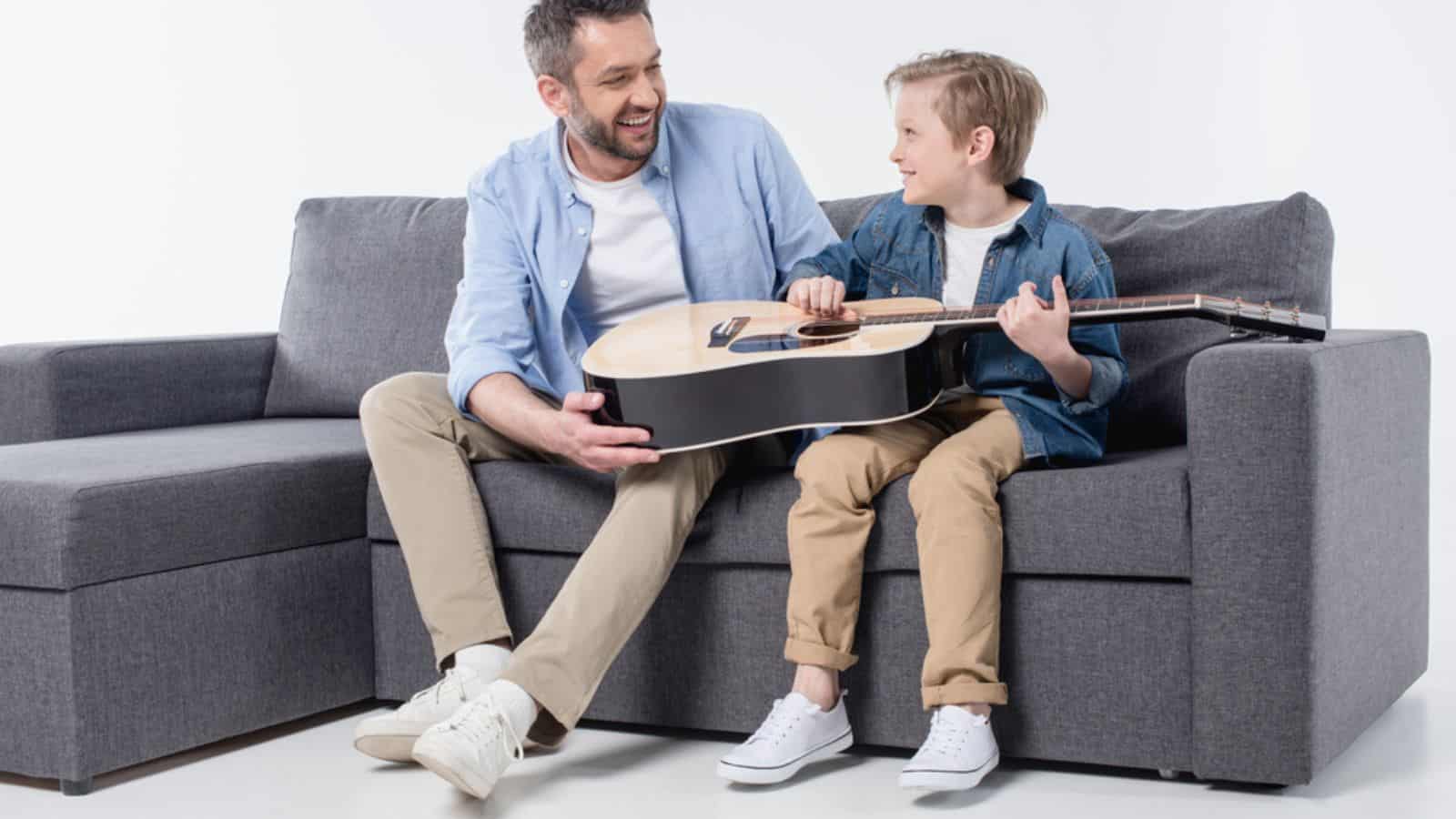 Father with son playing on guitar