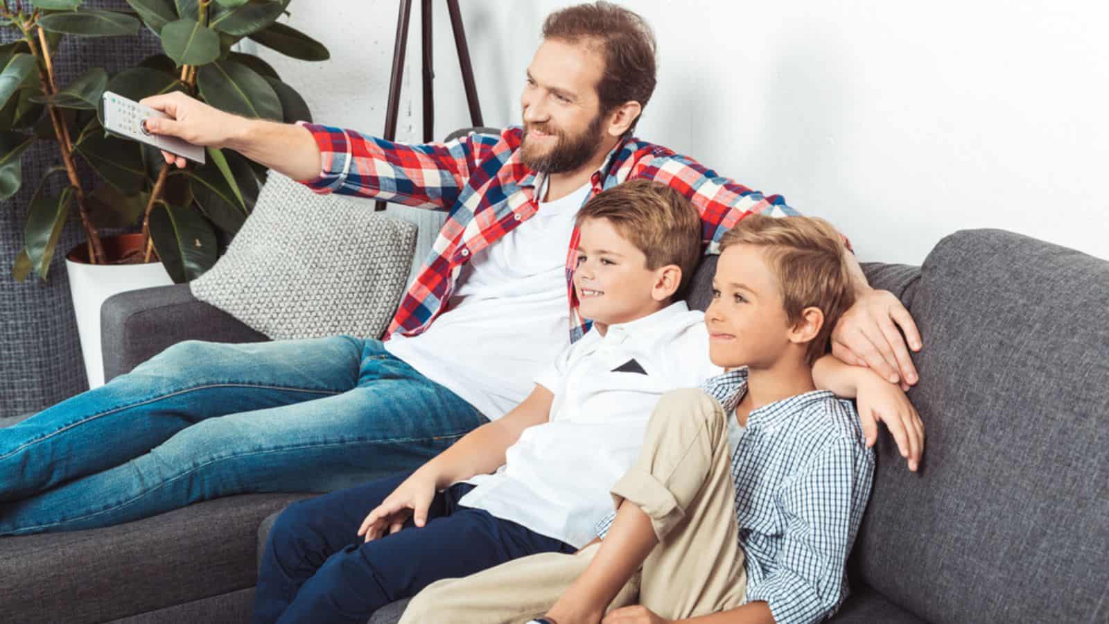 Father with sons watching tv