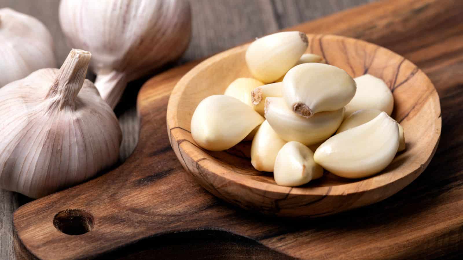Garlic Cloves and Bulb in vintage wooden bowl