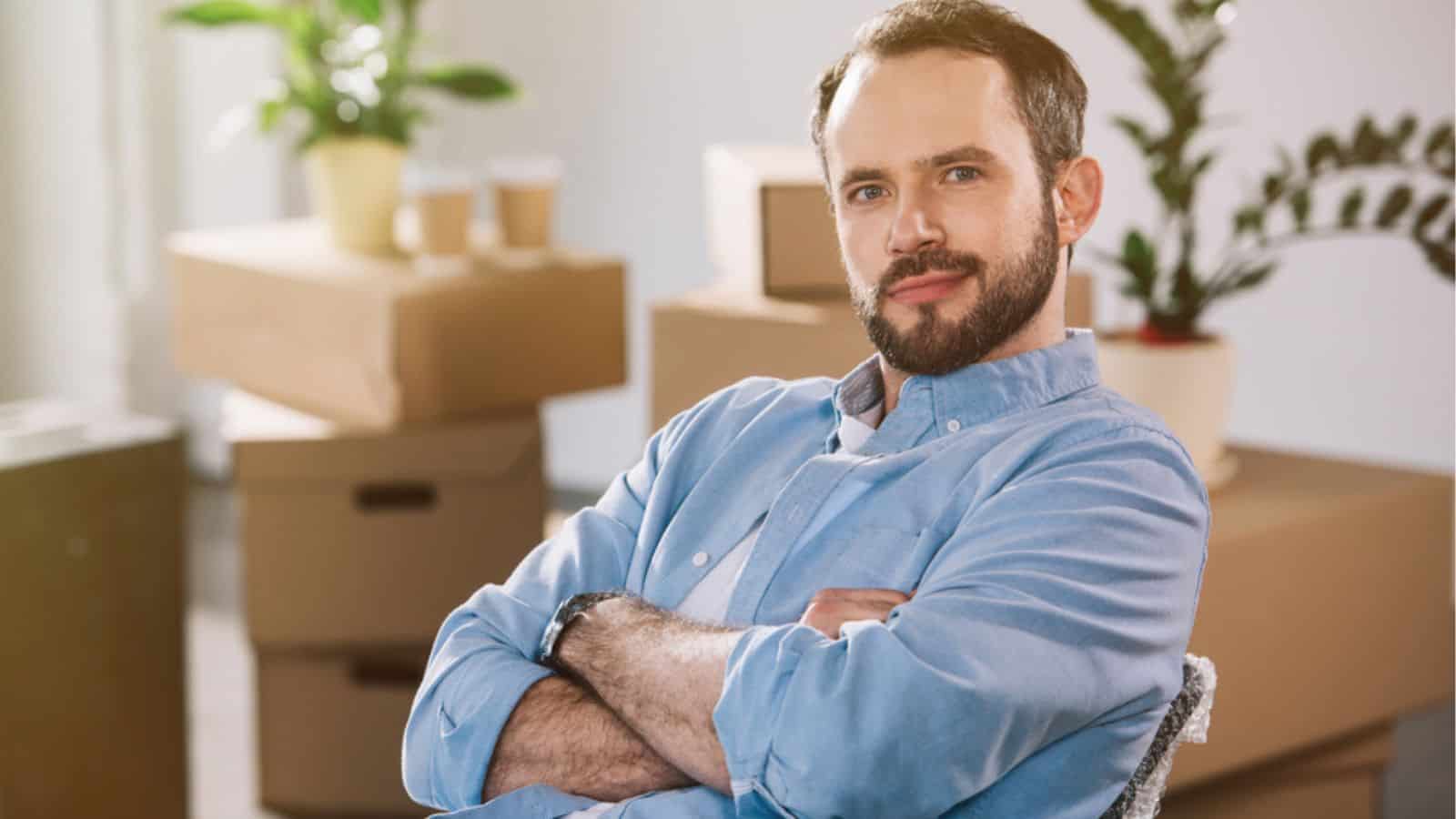 Handsome bearded man sitting with crossed arms