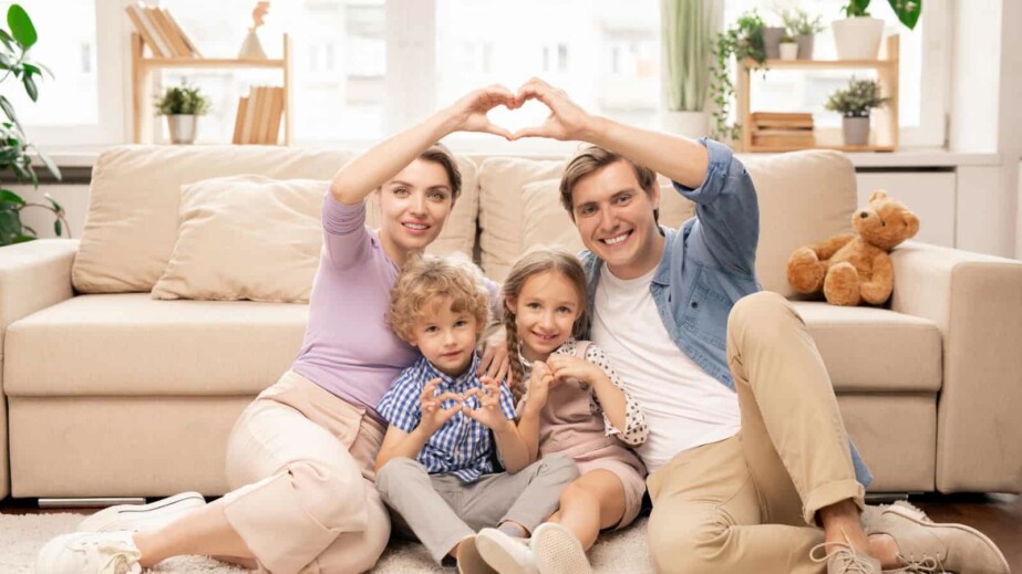 Happy Parents and Two Adorable Siblings Making Heart Shape