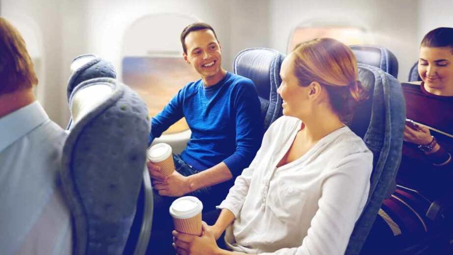 Happy passengers with coffee talking in Plane
