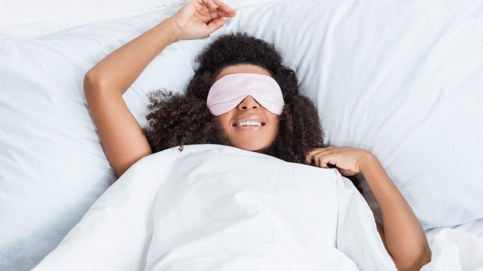 Joyful african american girl with eyes covered by sleeping