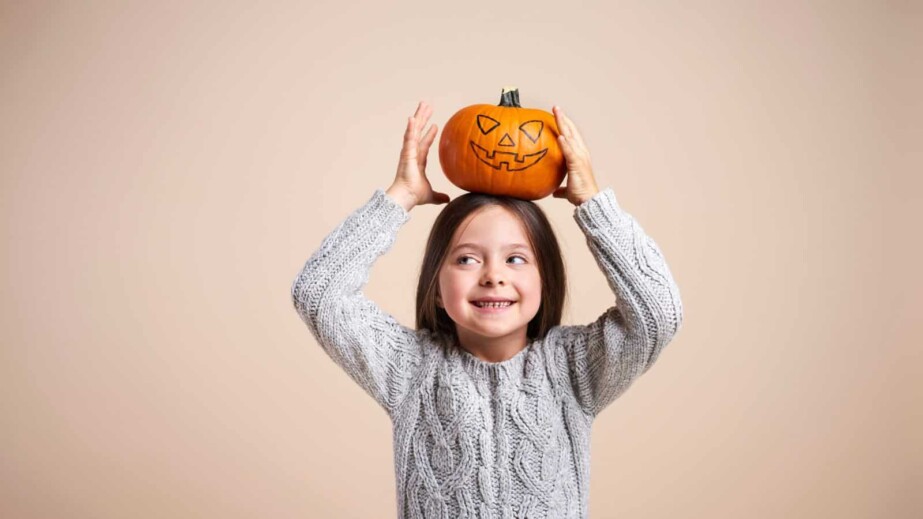 Kid Holding a Pumpkin