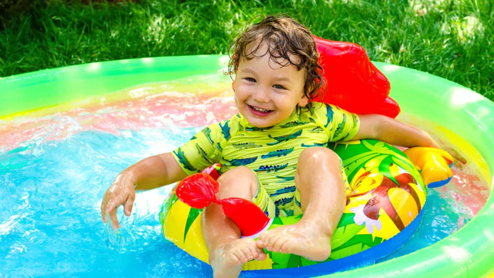 Little boy in swimming pool outdoors