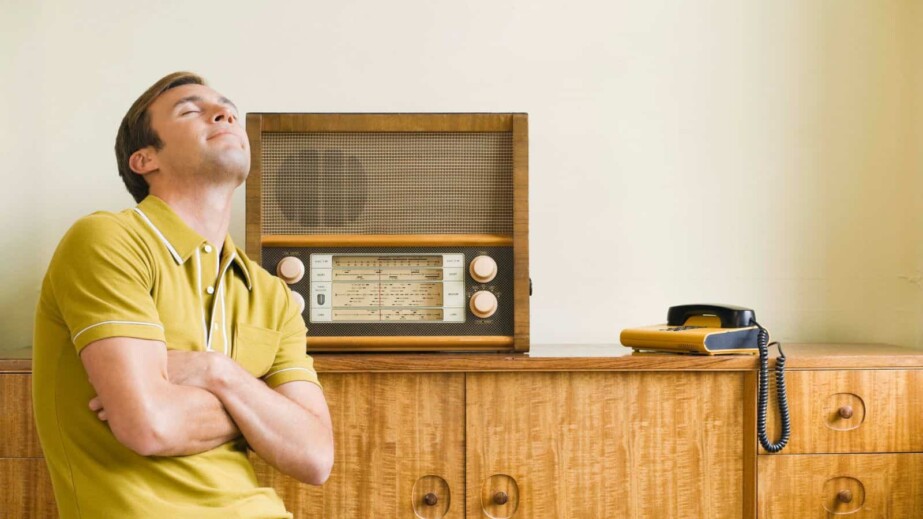 Man listening to antique radio
