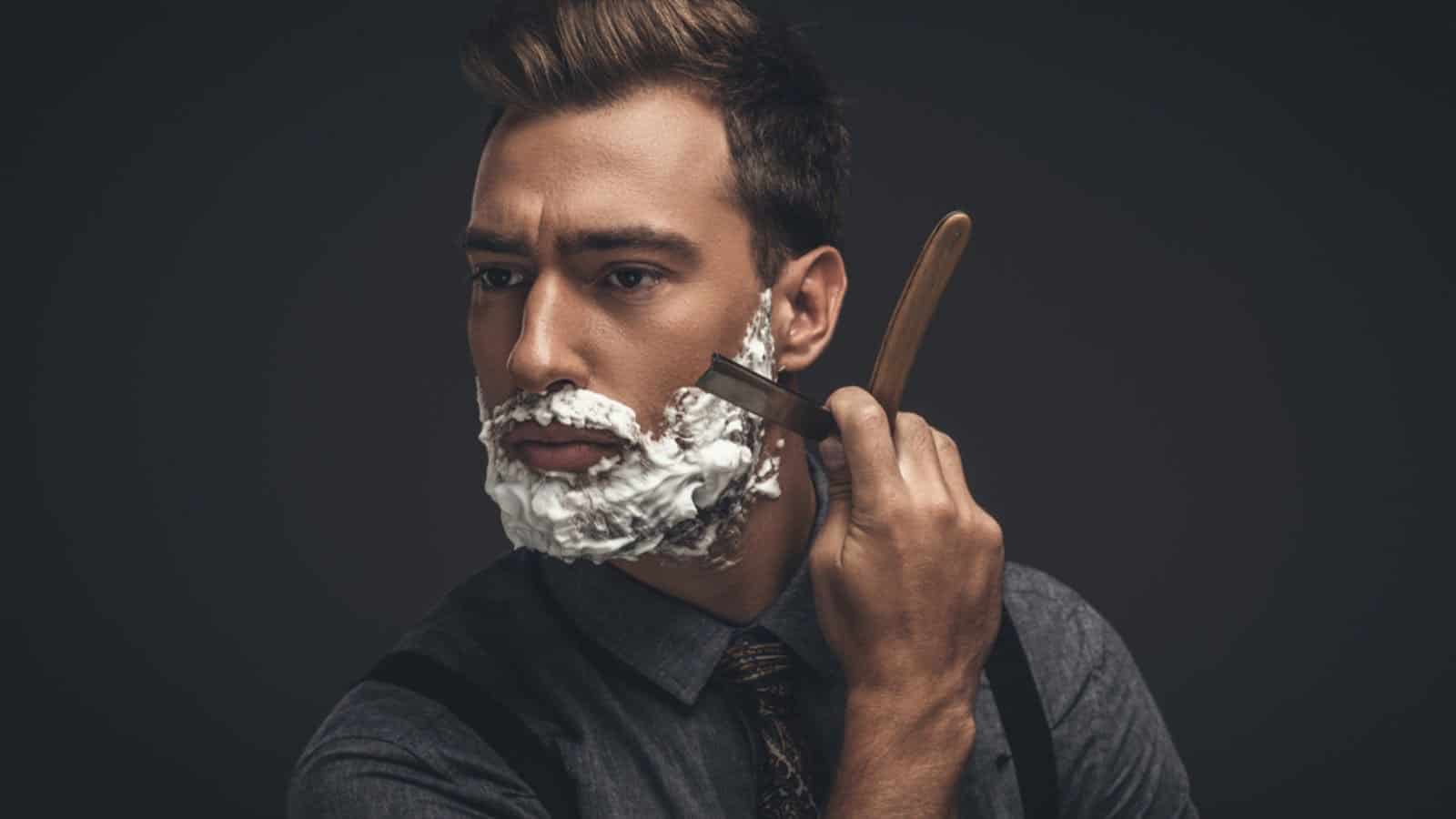 Man shaving with straight razor
