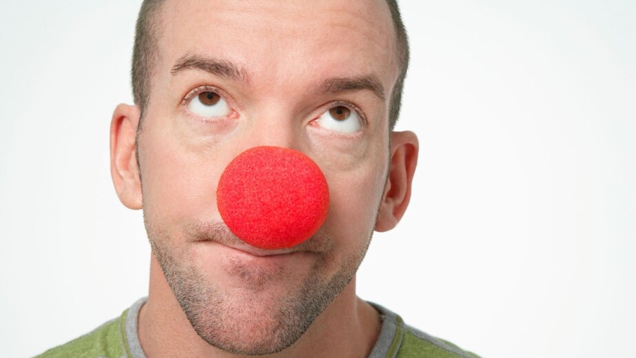 Man wearing clown nose