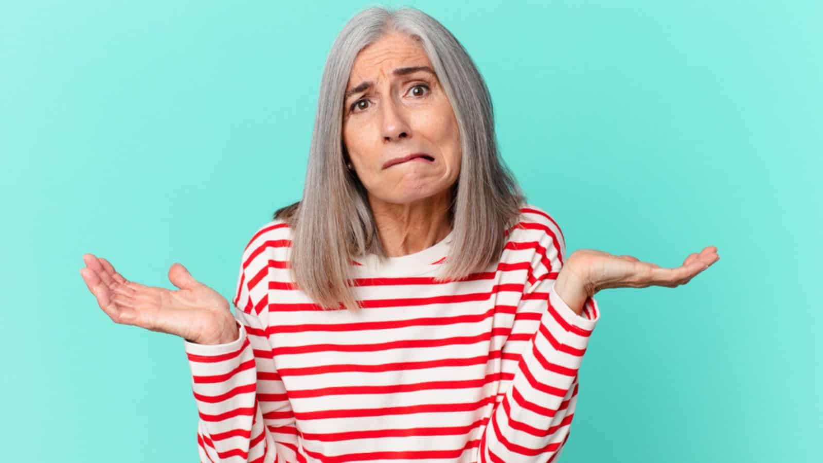 Middle age white hair woman feeling puzzled and confused