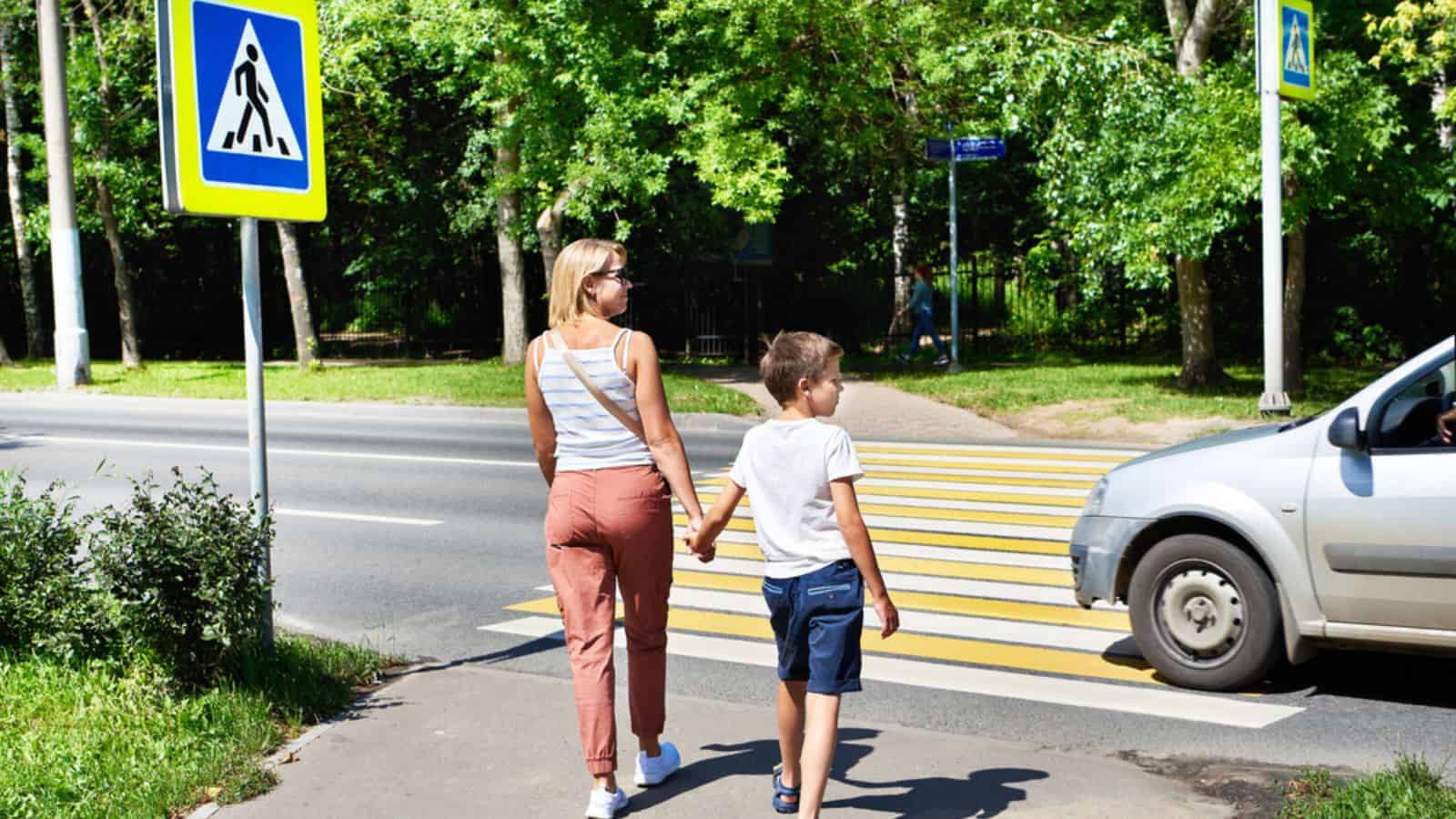 Mother and child walk on pedestrian crossing