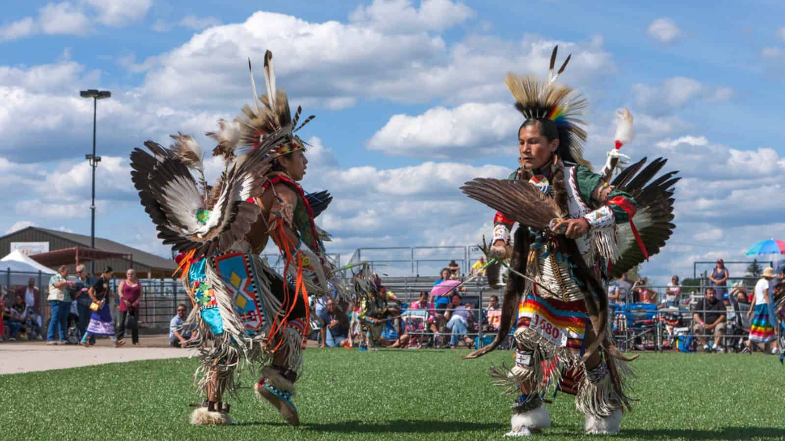 Opposing Native Americans at powwow dance