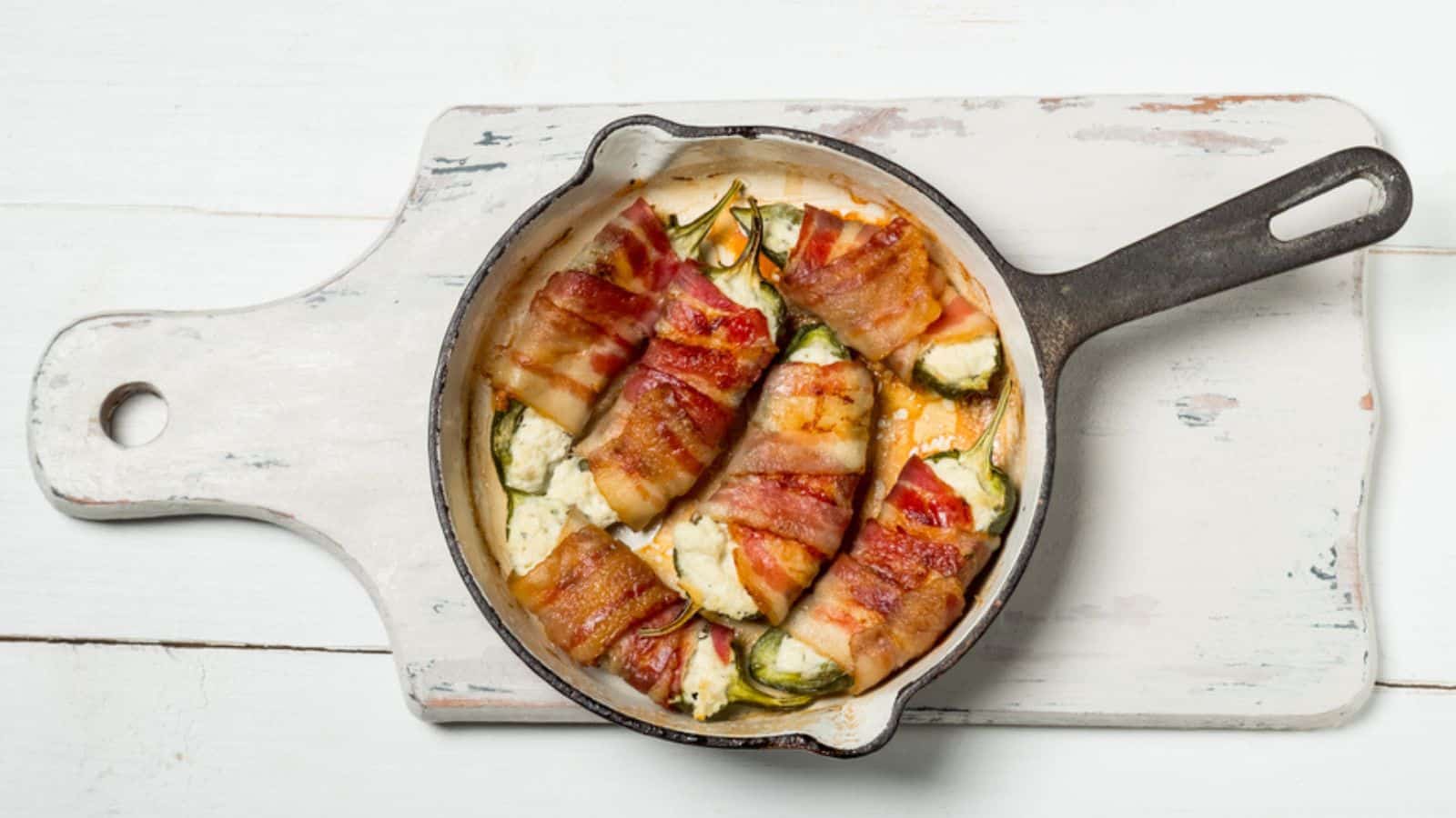 Pan with baked peppers stuffed with cheese and bacon