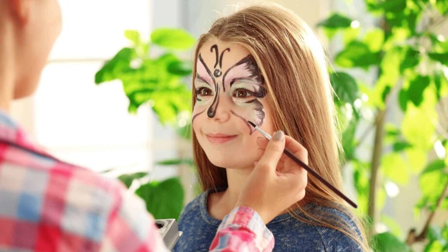 Person Doing Face Art in Girl's Face