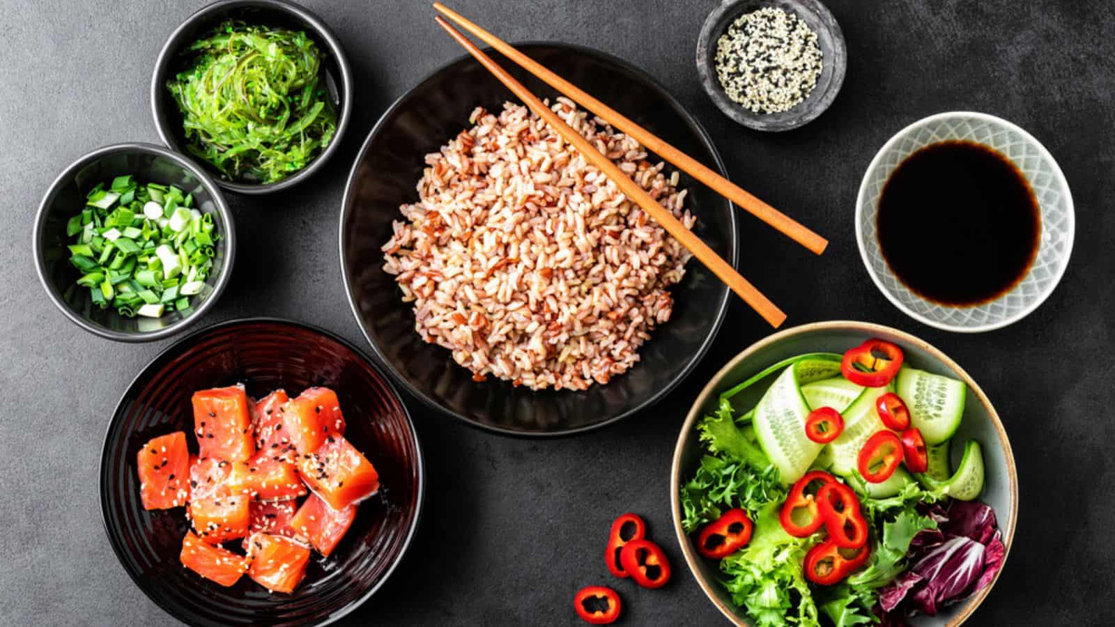 Poke bowl ingredients - brown rice, trout or salmon fille