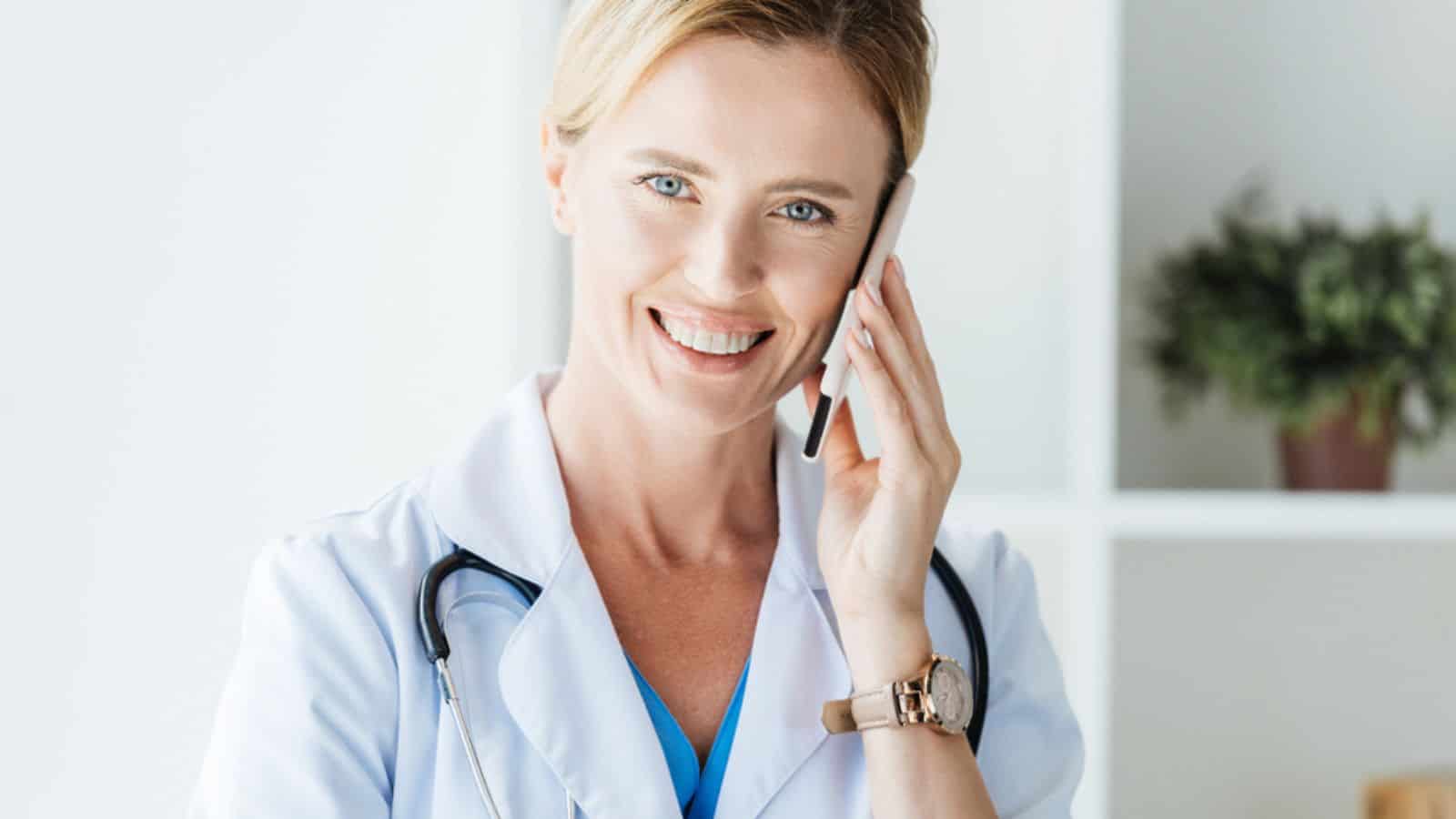 Portrait of happy female doctor in white coat