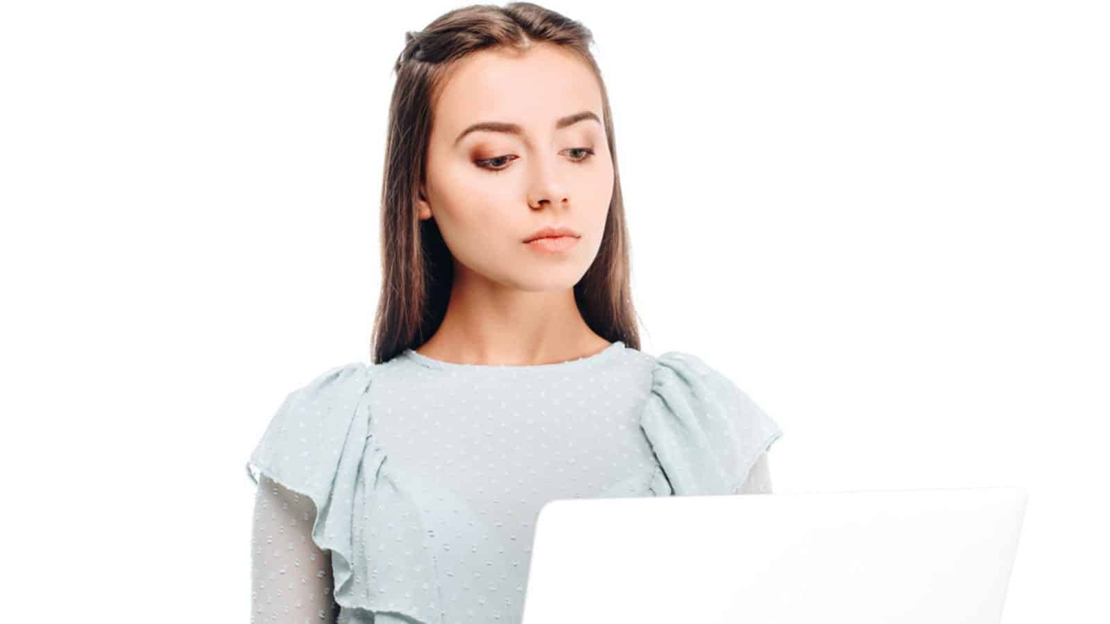 Portrait of young focused woman with laptop