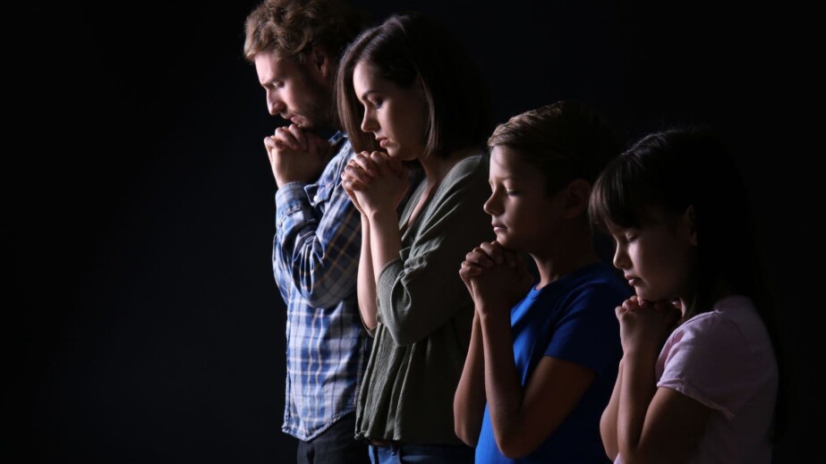 Praying Family on Dark Background