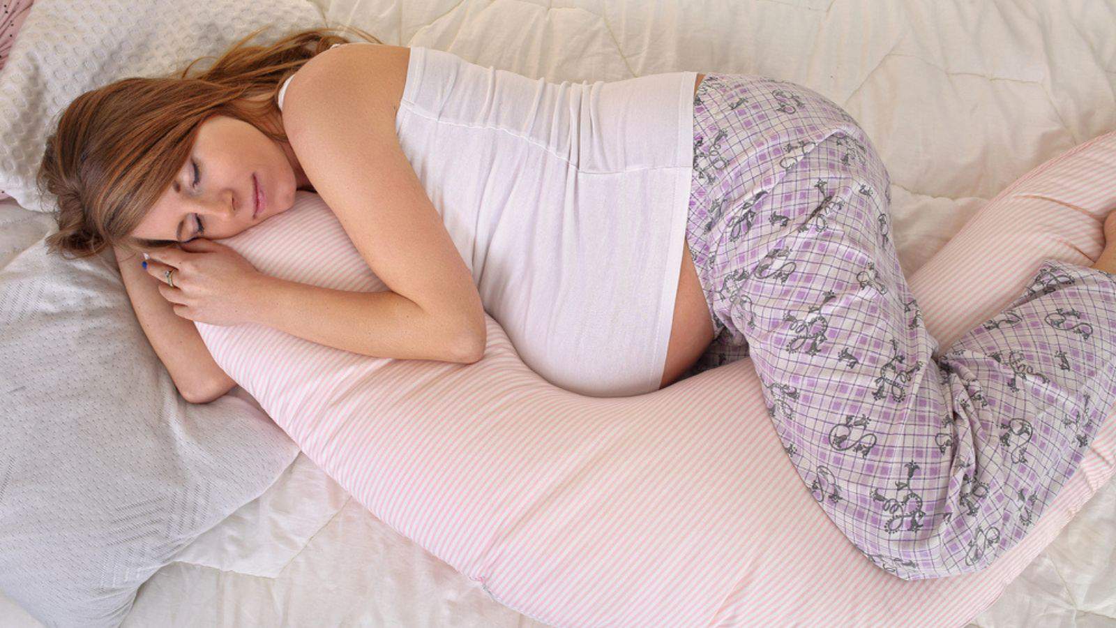 Pregnant woman sleeping peacefully in the bedroom