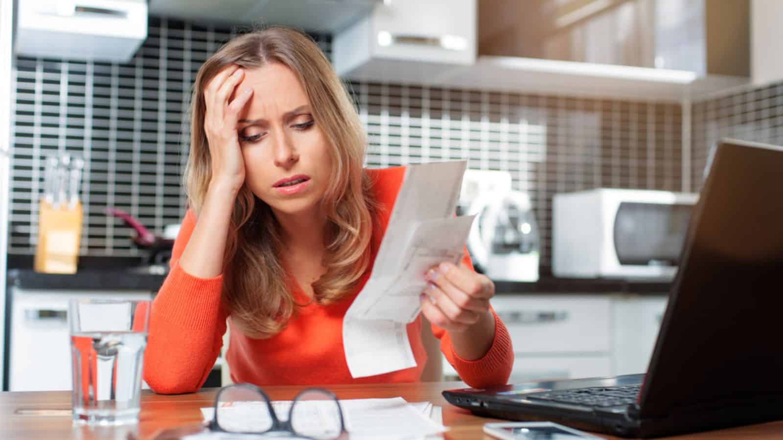 Sad and worried woman with her bills
