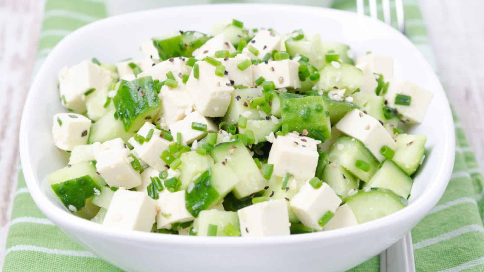 Salad with cucumber, tofu, green onions and sesame seeds closeup