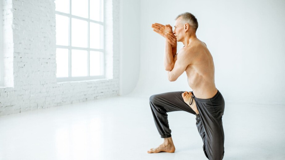 Senior Man Practising Yoga Indoors