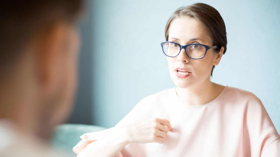 Serious Woman Talking to Colleague
