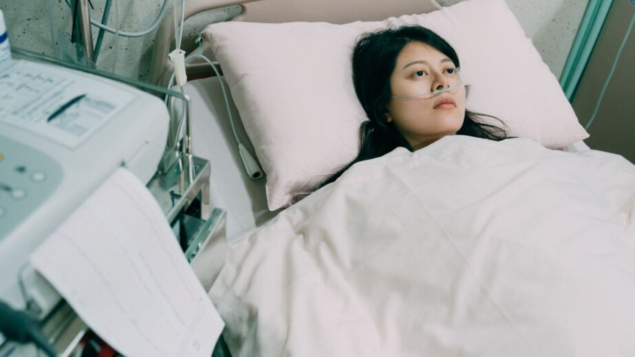Sick Woman Lying on a Hospital Bed
