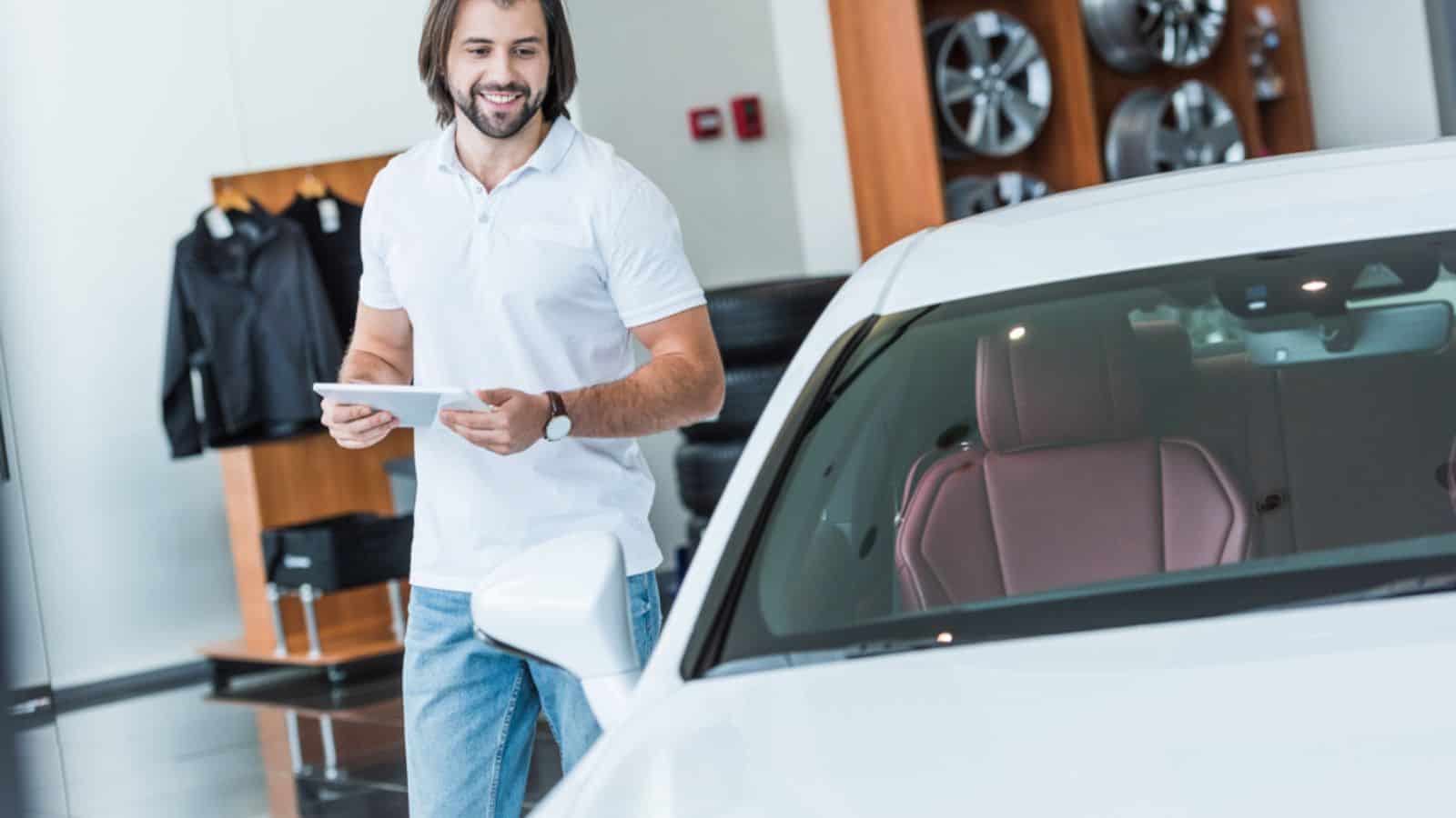 Smiling man planning to buy a new car