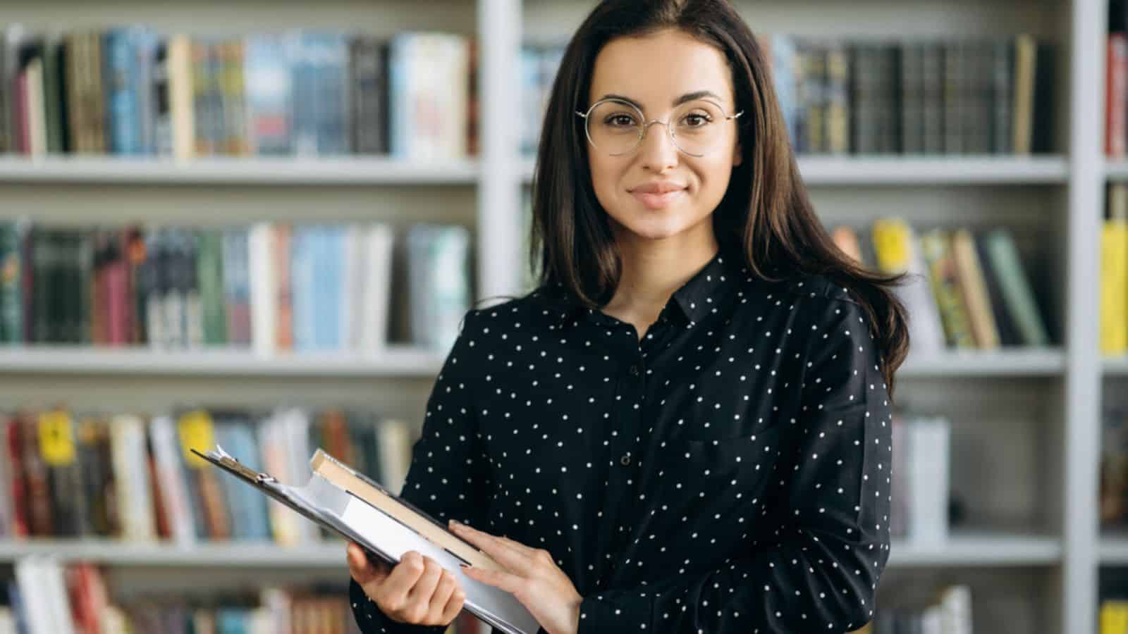Smiling woman holding books