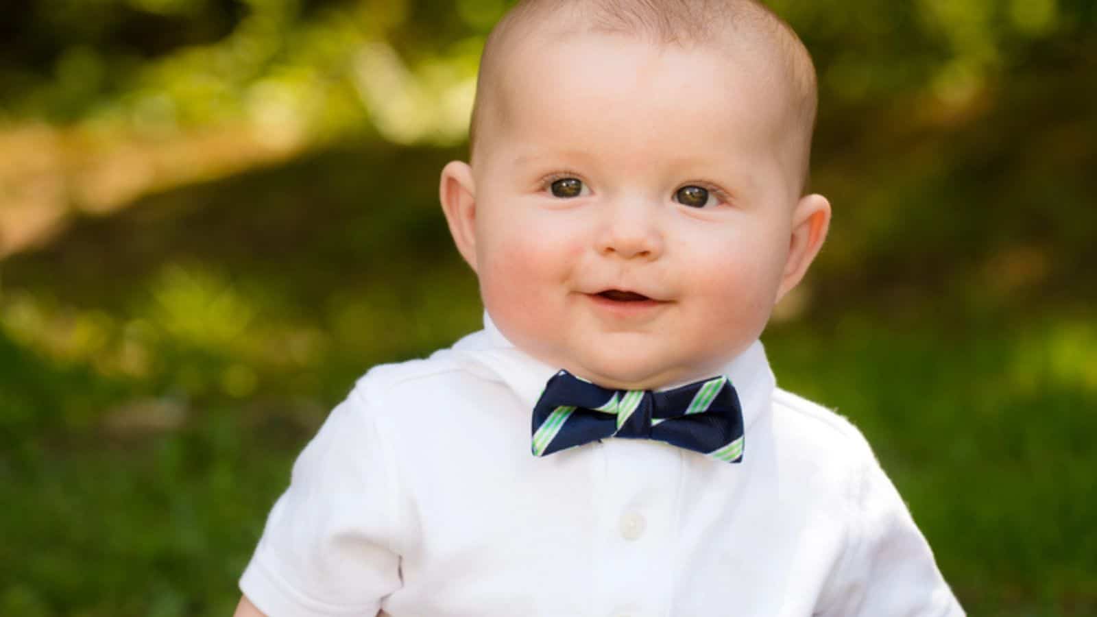 Spring portrait of cute infant baby boy wearing a bow tie