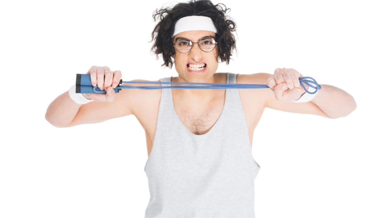 Thin sportsman in eyeglasses holding jump rope in hands