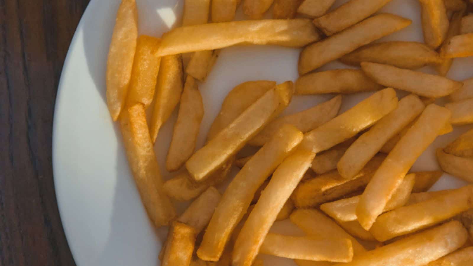 Top view of french fries over white plate